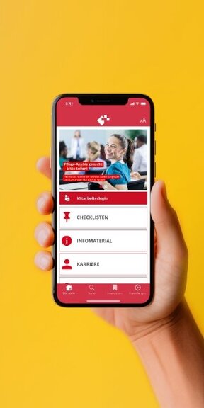 Vor einem farbigen Hintergrund hält eine Hand ein iPhone auf dem die App von Kinderkrankenhaus Wilhelmstift dargestellt wird