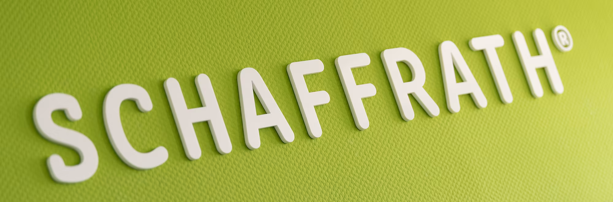 Schaffrath-Logo auf einer grünen Wand