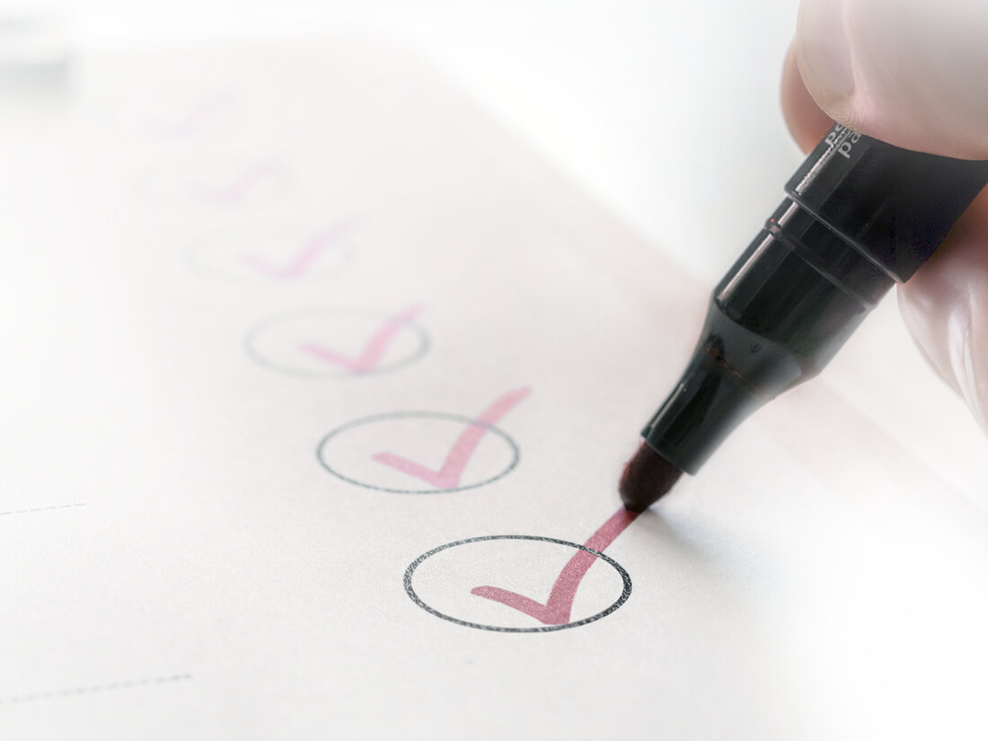Das Bild zeigt ein Blatt mit einer Checkliste mit Häkchen und einem Stift.